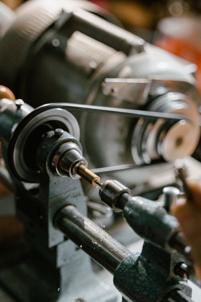 Detailed image of a metalworking machine tool with drill in action in an industrial setting.